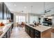 Modern kitchen features stainless steel appliances, dark cabinets and stone countertops at 10423 E Verbena Ln, Scottsdale, AZ 85255