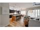 Open kitchen featuring dark cabinets, stainless appliances and an island with bar seating at 10423 E Verbena Ln, Scottsdale, AZ 85255