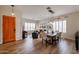 Bright living room featuring a dining area, hardwood floors, and well-lit windows with plantation shutters at 10423 E Verbena Ln, Scottsdale, AZ 85255