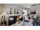 Comfortable living area with modern furniture, guitars mounted on the wall, and a bright dining area nearby at 10423 E Verbena Ln, Scottsdale, AZ 85255