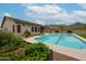 A large pool is surrounded by desert landscaping and offers serene views of the nearby mountains at 10423 E Verbena Ln, Scottsdale, AZ 85255