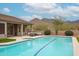 A sprawling pool with beautiful mountain views offers a tranquil escape in this stunning backyard at 10423 E Verbena Ln, Scottsdale, AZ 85255