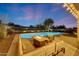 Outdoor living space showcasing a swimming pool, fire pit, patio seating, and desert landscaping at 10423 E Verbena Ln, Scottsdale, AZ 85255
