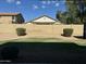 Private backyard with a lush green lawn, gravel area, and a tall block wall for added seclusion at 11570 W Pima St, Avondale, AZ 85323