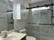 Modern bathroom featuring white marble design, sliding glass shower doors and black hardware for a touch of sophistication at 11570 W Pima St, Avondale, AZ 85323