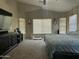 Serene bedroom with neutral tones, large windows, and a comfortable bed with blue bedding at 11570 W Pima St, Avondale, AZ 85323