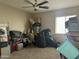 Cluttered bedroom with carpet flooring offering potential for transformation into a personalized, organized space at 11570 W Pima St, Avondale, AZ 85323