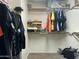 Organized walk-in closet with shelving, hanging space, and ample storage for clothing and accessories at 11570 W Pima St, Avondale, AZ 85323
