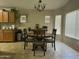 Charming dining area with a round table, wooden chairs, and ample natural light from multiple windows at 11570 W Pima St, Avondale, AZ 85323