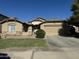 Attractive single-level house featuring a well-maintained lawn, neutral paint, and an attached two-car garage at 11570 W Pima St, Avondale, AZ 85323