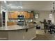 Well-equipped kitchen featuring wood cabinetry, stainless steel appliances, and a convenient breakfast bar at 11570 W Pima St, Avondale, AZ 85323