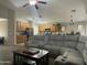 Open-concept living area with a comfortable sectional, dark wood coffee table, and an adjacent kitchen at 11570 W Pima St, Avondale, AZ 85323