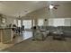 Open concept living room with a kitchen bar, dining area, and spacious seating, perfect for modern living and entertaining at 11570 W Pima St, Avondale, AZ 85323