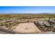 Wide aerial shot shows available lot with community, golf course, and distant mountain views at 12053 W Palo Brea Ln, Peoria, AZ 85383