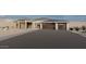 Modern home with a three-car garage, desert landscaping, and a spacious driveway at 12053 W Palo Brea Ln, Peoria, AZ 85383
