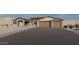 Beautiful desert home features large driveway, stone accents, and a convenient two-car garage at 12053 W Palo Brea Ln, Peoria, AZ 85383