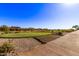 Panoramic view of a well-manicured golf course situated within a desert landscape and neighborhood at 12053 W Palo Brea Ln, Peoria, AZ 85383