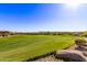Lush green golf course view with desert landscape and neighborhood homes, showcasing scenic surroundings at 12053 W Palo Brea Ln, Peoria, AZ 85383