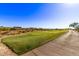 Beautiful golf course view with lush green fairway and blue sky background for a relaxing day at 12053 W Palo Brea Ln, Peoria, AZ 85383