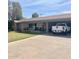 Charming single-story home featuring a lush lawn, inviting carport, and a welcoming front patio at 1257 E Dartmouth St, Mesa, AZ 85203