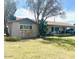 Well-maintained single-story home boasting a lush front lawn, mature trees, and stone accents at 1257 E Dartmouth St, Mesa, AZ 85203