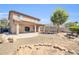 Large backyard with covered patio, desert landscaping, and ample space for recreation at 14521 W Gelding Dr, Surprise, AZ 85379