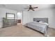 Inviting bedroom showcasing a plush bed, dresser, and access to a pristine bathroom at 14521 W Gelding Dr, Surprise, AZ 85379