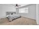 Cozy bedroom featuring carpet floors, a ceiling fan, and a comfortable bed at 14521 W Gelding Dr, Surprise, AZ 85379