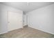This is a spacious bedroom with neutral carpeting and a double door closet at 14521 W Gelding Dr, Surprise, AZ 85379