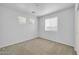 Bright bedroom features neutral walls, plush carpeting, and ample natural light from multiple windows at 14521 W Gelding Dr, Surprise, AZ 85379