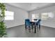 Bright dining area features modern table with blue chairs and ample natural light at 14521 W Gelding Dr, Surprise, AZ 85379