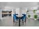 Stylish dining area adjacent to the kitchen, featuring blue chairs and decorative plants at 14521 W Gelding Dr, Surprise, AZ 85379