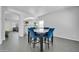 Open dining area with a four-seat table, blue chairs and direct access to other living spaces at 14521 W Gelding Dr, Surprise, AZ 85379
