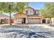 Inviting two-story home with a well-manicured front yard and attached two car garage at 14521 W Gelding Dr, Surprise, AZ 85379