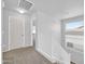 Bright hallway with white banister and neutral carpeting leading to the upper level of the home at 14521 W Gelding Dr, Surprise, AZ 85379