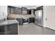 Well-equipped kitchen featuring sleek dark cabinets, stainless steel appliances, and coordinated backsplash at 14521 W Gelding Dr, Surprise, AZ 85379
