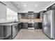 Stylish kitchen with dark wood cabinetry, stainless steel appliances, and durable countertops at 14521 W Gelding Dr, Surprise, AZ 85379