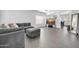 Comfortable living room with gray sectional, modern TV, and abundant natural light at 14521 W Gelding Dr, Surprise, AZ 85379