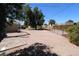 Expansive backyard with stone pavers, chain-link fence, and shade trees at 1524 E 23Rd Ave, Apache Junction, AZ 85119
