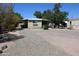 Charming single-story home featuring a cozy covered porch and well-maintained gravel landscaping at 1524 E 23Rd Ave, Apache Junction, AZ 85119