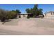 Charming home featuring a well-maintained yard with mature trees, offering shade and curb appeal at 1524 E 23Rd Ave, Apache Junction, AZ 85119