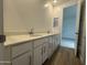 Bathroom featuring double sink vanity with white cabinets and modern faucets at 15777 W Cheryl Dr, Waddell, AZ 85355