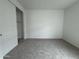 Comfortable bedroom with carpet, a sliding-door closet and neutral wall paint at 15777 W Cheryl Dr, Waddell, AZ 85355