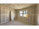 Bedroom with a large window and ample wall space for furniture and decoration at 15777 W Cheryl Dr, Waddell, AZ 85355