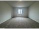 A cozy bedroom featuring neutral carpet, natural light and ample space at 15777 W Cheryl Dr, Waddell, AZ 85355