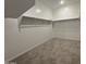 Walk-in closet with neutral carpet, white walls, and a rack to hang clothes at 15777 W Cheryl Dr, Waddell, AZ 85355