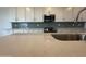 Kitchen island with countertop, stainless steel appliances, and ample cabinet space at 15777 W Cheryl Dr, Waddell, AZ 85355