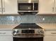 Modern kitchen featuring stainless steel appliances and stylish backsplash at 15777 W Cheryl Dr, Waddell, AZ 85355