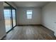 Bright living room with tile flooring and a sliding glass door leading to the patio at 15777 W Cheryl Dr, Waddell, AZ 85355