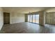 A spacious living room with large sliding doors for natural light and indoor-outdoor living at 15777 W Cheryl Dr, Waddell, AZ 85355